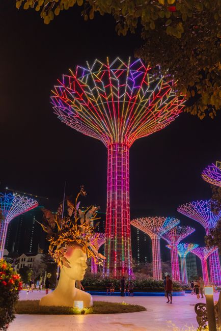 Stunning night view of Supertree Grove in Singapore's Gardens by the Bay, adorned with vibrant lights.