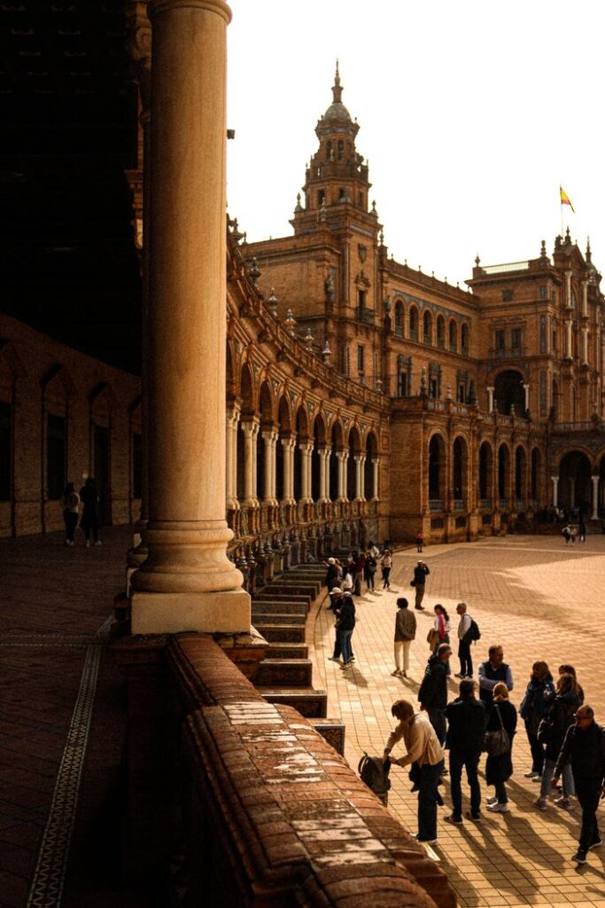 Visitors at the historic Plaza de España in Seville, capturing its majestic architecture and lively atmosphere.