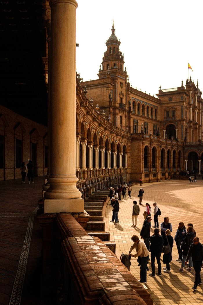 Visitors at the historic Plaza de España in Seville, capturing its majestic architecture and lively atmosphere.