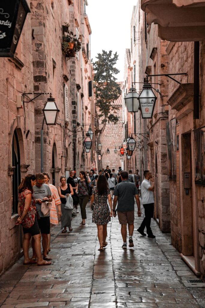 Explore a bustling narrow street in Dubrovnik's historic Old Town, capturing Croatia's Mediterranean charm.